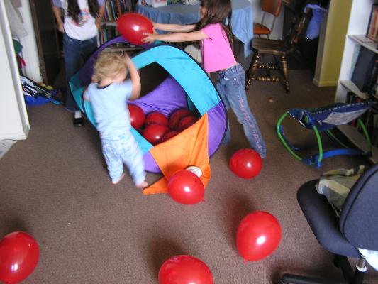 Noah and Andrea play with balloons.