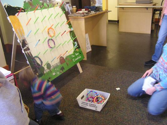 Noah plays  a ring toss game