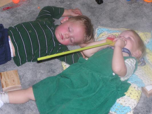 Sarah likes to copy Noah, so when he fell asleep early playing on the floor she pretended to sleep to.