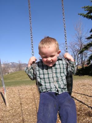 Noah swings at the park.