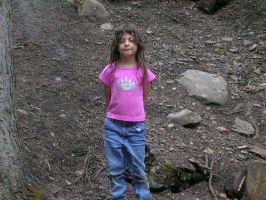 Andrea in front of a bunch of broken rocks.