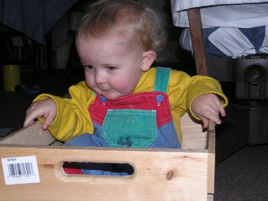 Noah plays in his new wooden box.