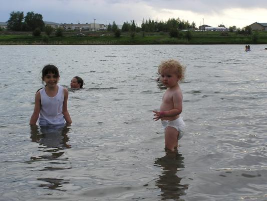 Malia and Noah play in the lake.