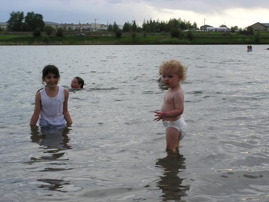 Malia and Noah play in the lake.
