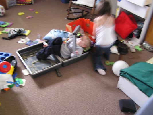 Noah and Andrea play in the suitcase.