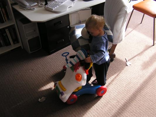Noah pushes around his penguin.