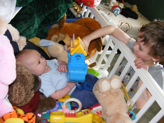 Noah got all the baby toys for Joshua to play with.