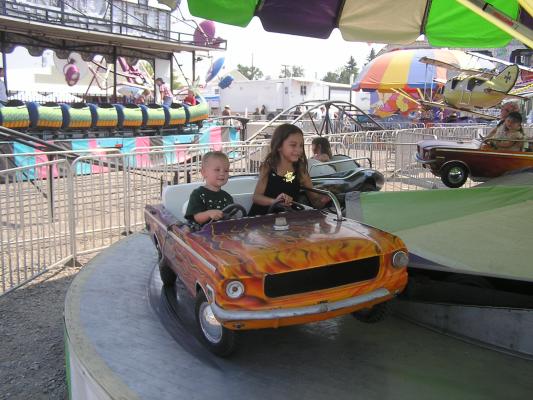 Noah and Andrea ride at the fair.