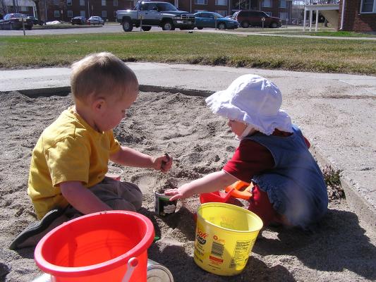 Noah and Sarah play in the sand