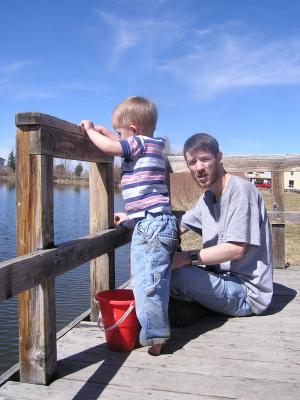 Noah throws rocks off the dock.