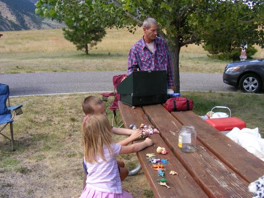 Noah and Sarah play with Mickala's toys at the Johnston's table.
