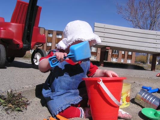 Sarah hides behind a shovel.