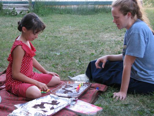 We made some cake for Bea's birthday. Malia helps Katie put on the candles