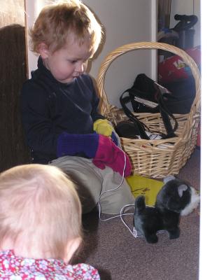 Sarah and Noah play with the toy dog.