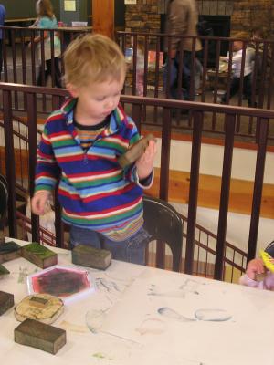 Noah looks at a bird stamp