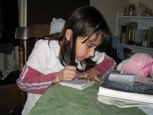 Malia writes in Noah's notebook.