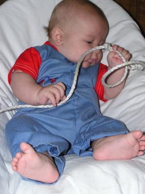 Noah inspects the quality of the rope.