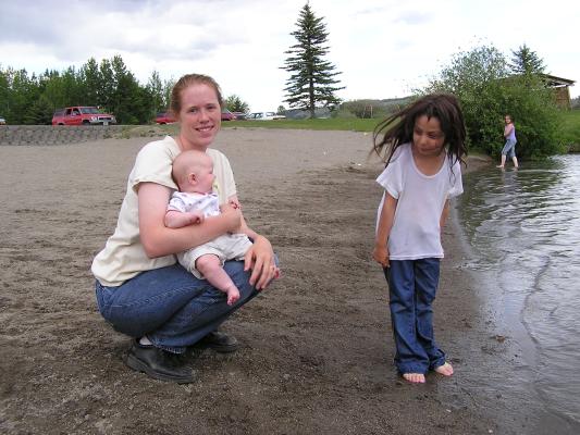 Katie holds Sarah next to a very wet Andrea.