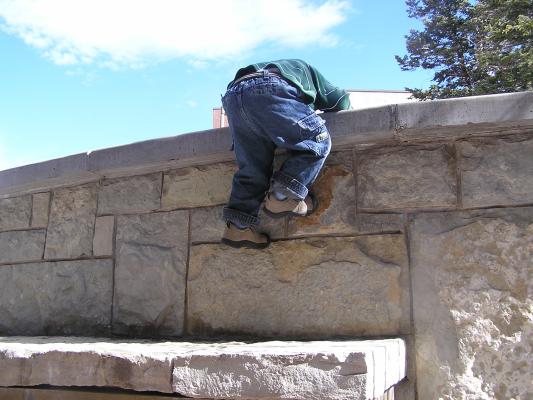 Noah climbs the wall.