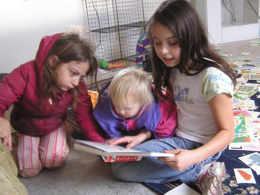 Andrea and Sarah listen as Malia reads