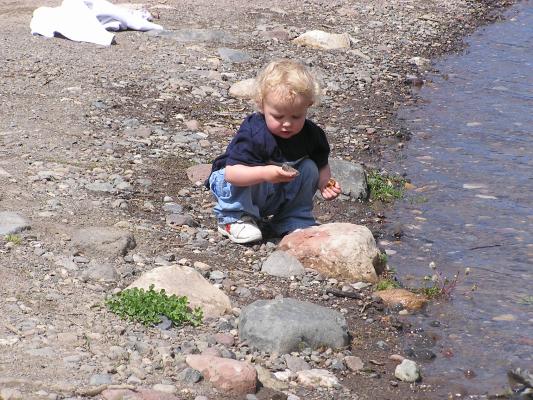Noah inspects some interesting rocks.