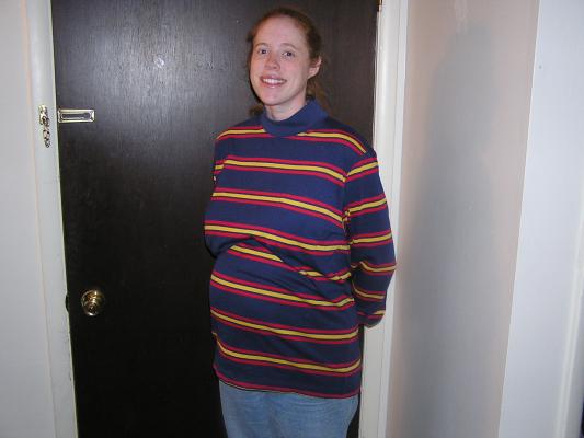 Katie shows off her big round tummy.