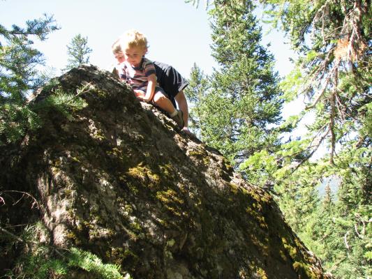 Noah and David climb a rock