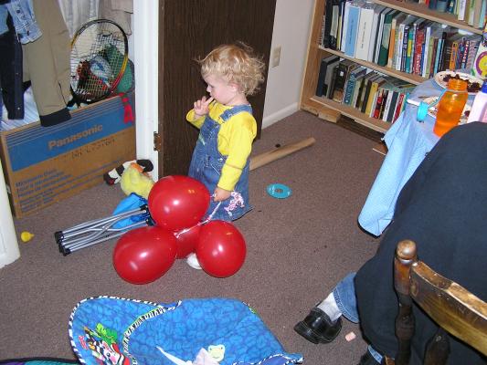 Noah plays with the red balloons.