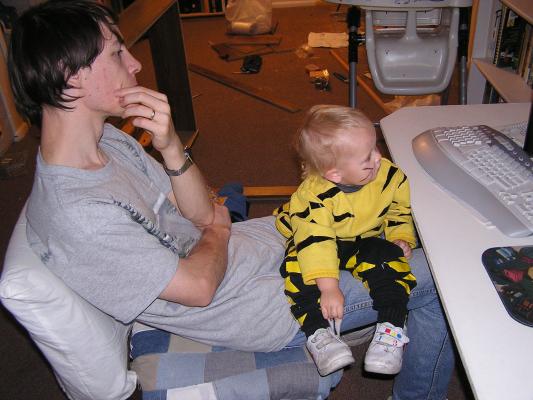 David and Noah watch a cartoon on the computer.