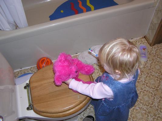 Sarah brushes the bear's teeth