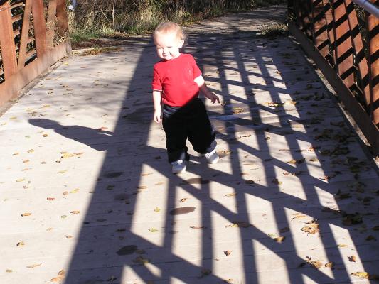 Noah walks across the bridge.