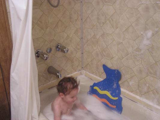 Noah enjoys throwing bubbles on the wall.