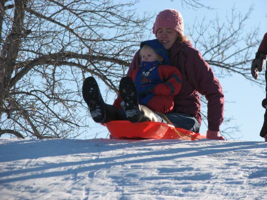 Katie and Sarah go down the hill.