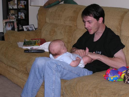 David plays with Noah's legs.
