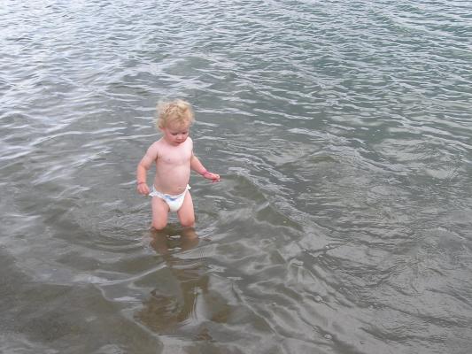 Noah wades in the lake.