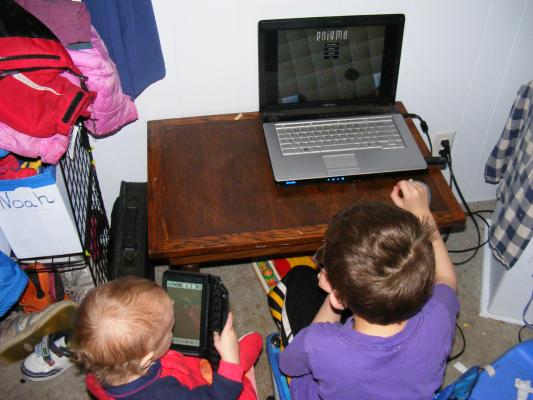 Joshua and Noah play on the computer. 