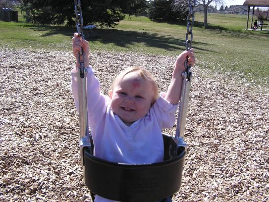 Sarah swings at the park.