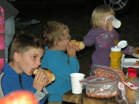 Max Noah and Sarah eat hot dogs at the chruch campout
