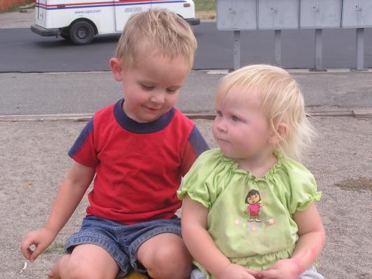 Noah and Sarah on a tire at the park.