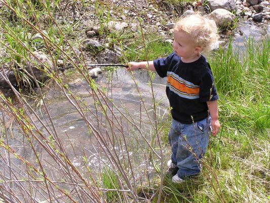 Noah stirs with his stick.
