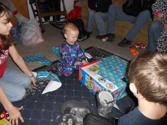 Joshua opens a birthday gift. 