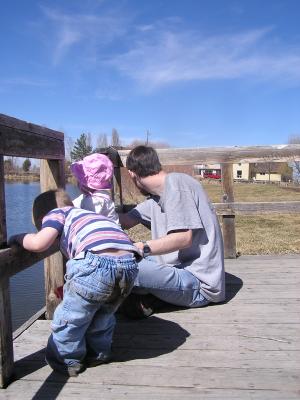 Noah and Sarah throw rocks off the dock.