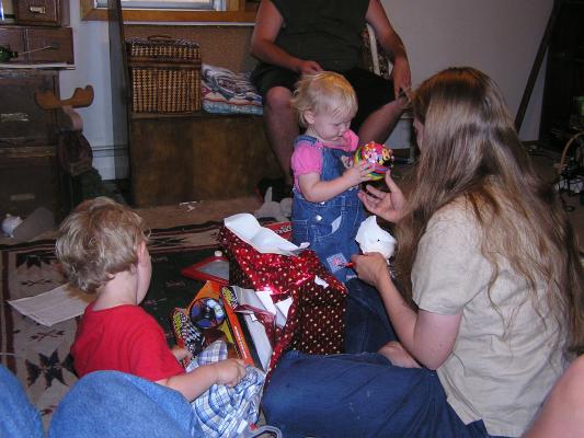 Noah, Sarah and Katie open birthday presents