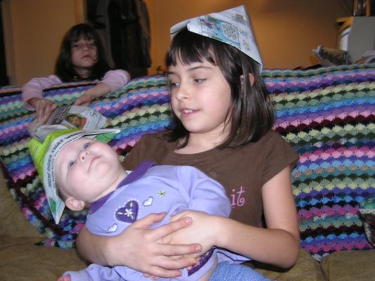 Malia and Sarah play with paper hats.