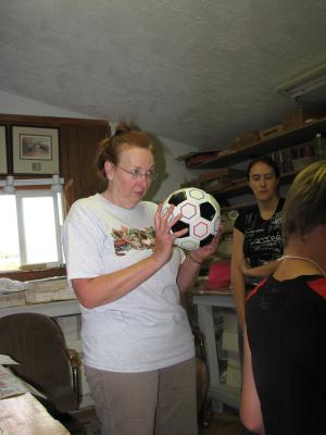 Kathy shows the kids the soccer balls we are sending to tellthe gospel.