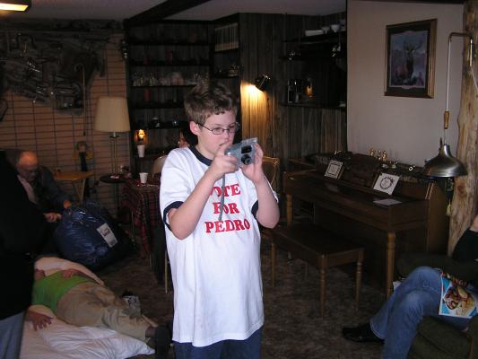 Joe tries to figure out how to take a picture with Jamie's new camera.