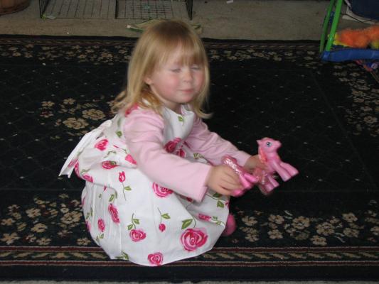Grandma Eder got Sarah a pretty dress. Grandma Cline got her a pony.