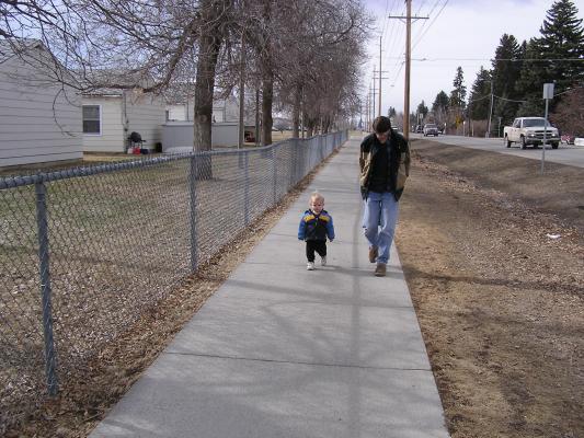 Noah walks with his daddy.