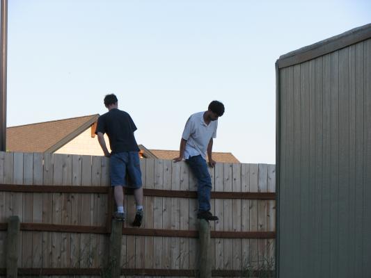 Jim and Mike climb the fence