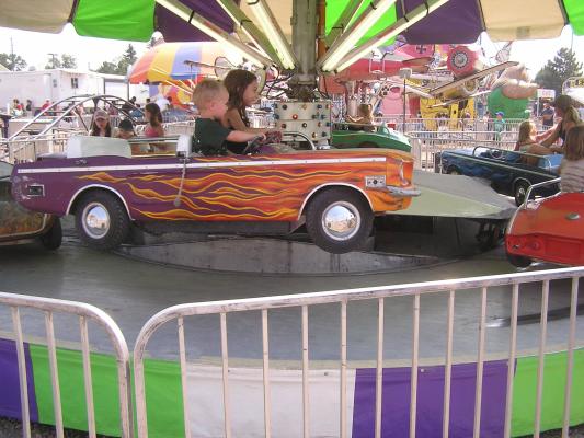 Noah and Andrea on a carnival ride at the fair.